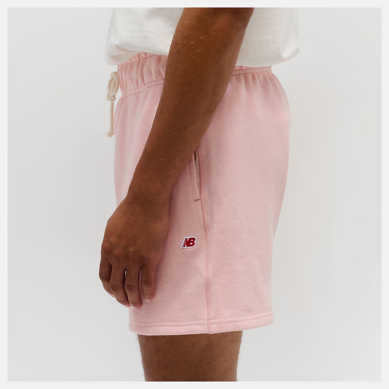 New Balance Made in USA Core Short with premium French Terry fabric, mid-rise cut, drawcord waistband, and embroidered patch logo.