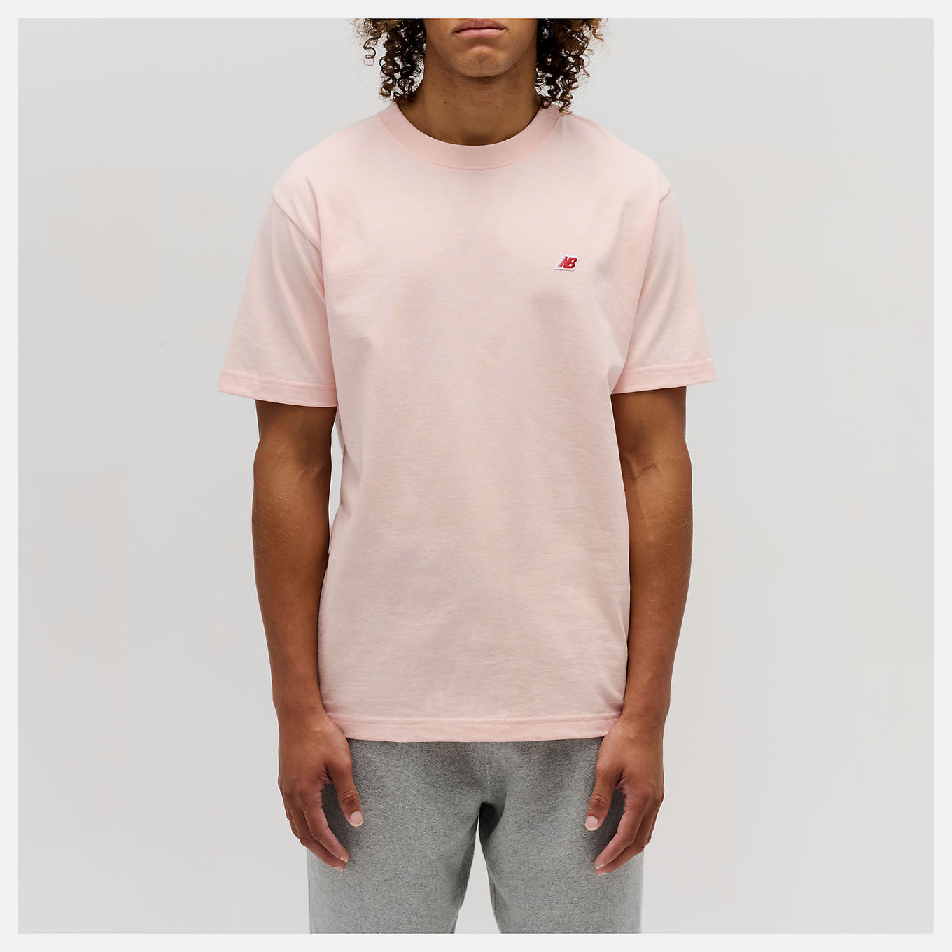 Close-up of the MADE in USA Core T-Shirt, highlighting its premium fabric, classic crewneck silhouette, and embroidered patch logo.