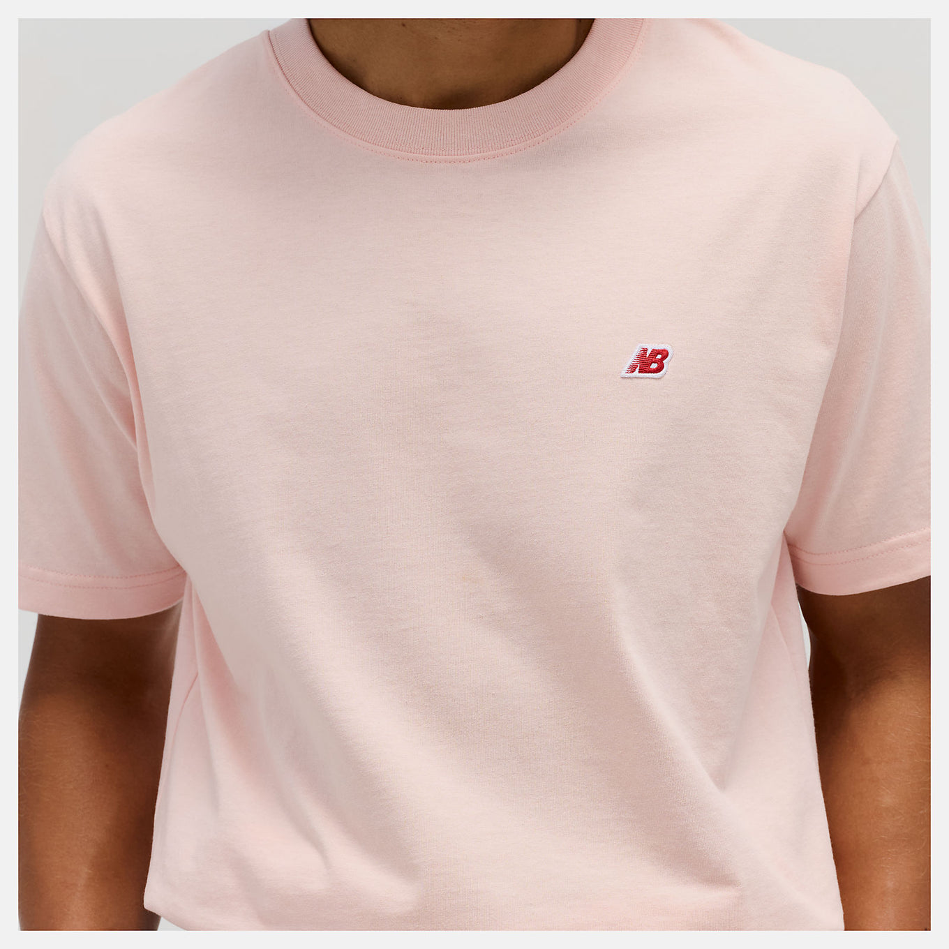 Close-up of the MADE in USA Core T-Shirt, highlighting its premium fabric, classic crewneck silhouette, and embroidered patch logo.