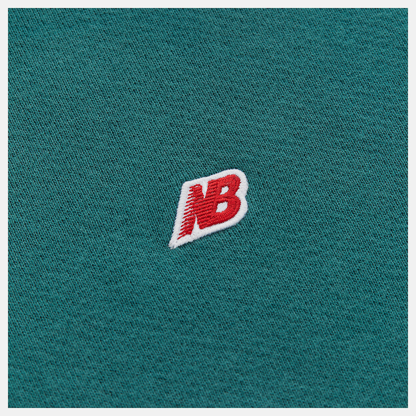 Made in USA Core Hoodie in soft French terry fabric, featuring a double-lined hood and embroidered patch logo, embodying premium quality and timeless sportswear design.