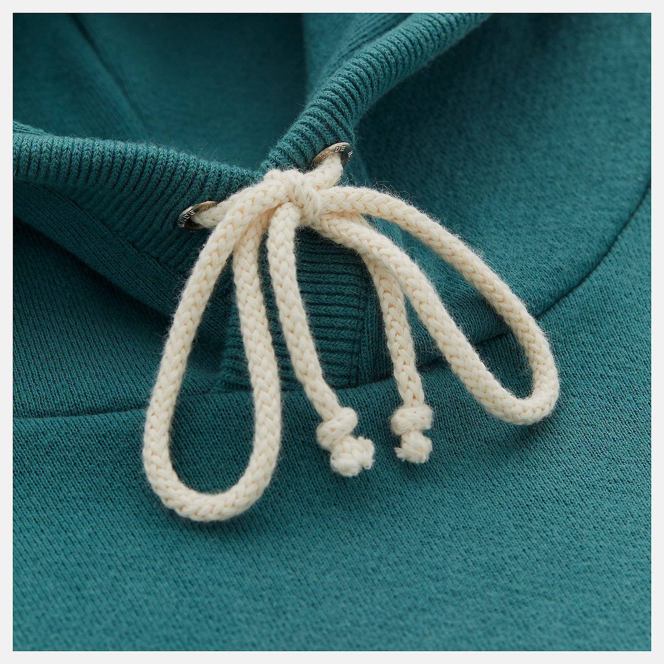 Made in USA Core Hoodie in soft French terry fabric, featuring a double-lined hood and embroidered patch logo, embodying premium quality and timeless sportswear design.