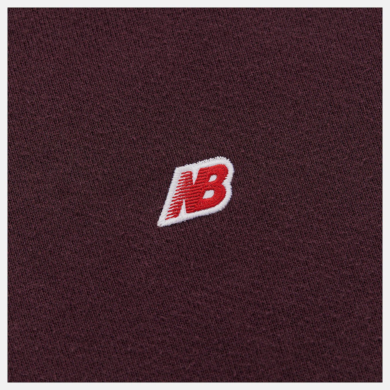 Made in USA Core Hoodie in soft French terry fabric, featuring a double-lined hood and embroidered patch logo, embodying premium quality and timeless sportswear design.