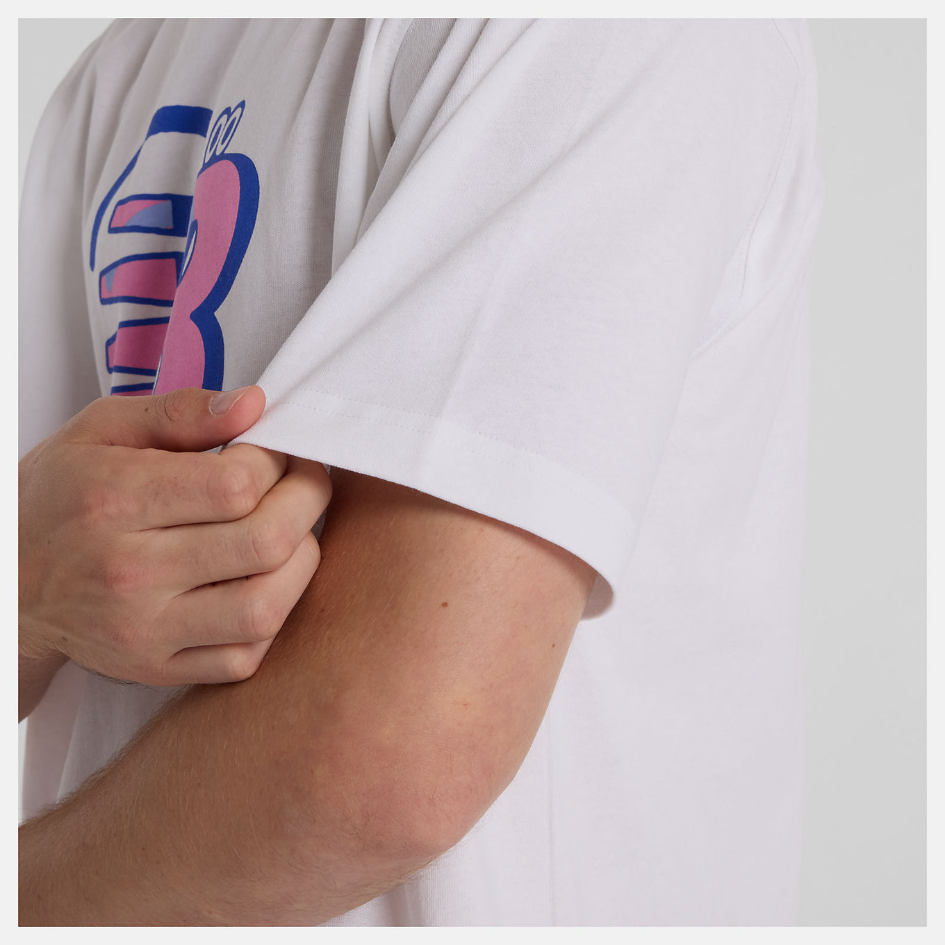 Face Oka x New Balance T-shirt featuring colorful Flying NB graphics on front and back