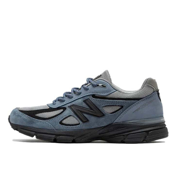 The revival of the New Balance 990 v4 after 8 years, featuring gray mesh with blue suede overlays and black details. Made in the USA with EnCap cushioning for comfort.