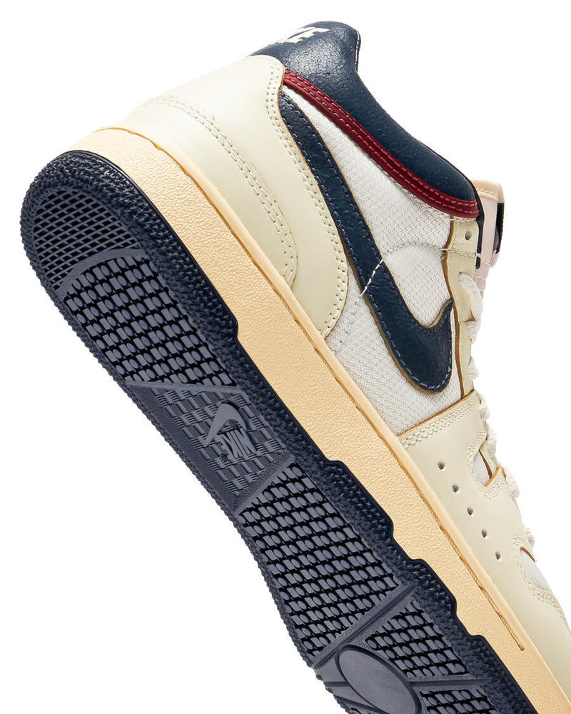 Retro-inspired Sneaker: Coconut Milk Leather with Midnight Navy Accents, Checkered Tongue Label, Painted Midsole