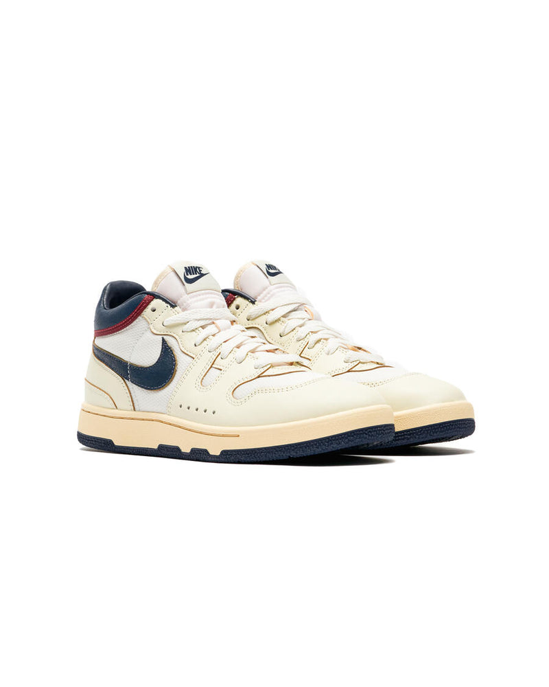 Retro-inspired Sneaker: Coconut Milk Leather with Midnight Navy Accents, Checkered Tongue Label, Painted Midsole