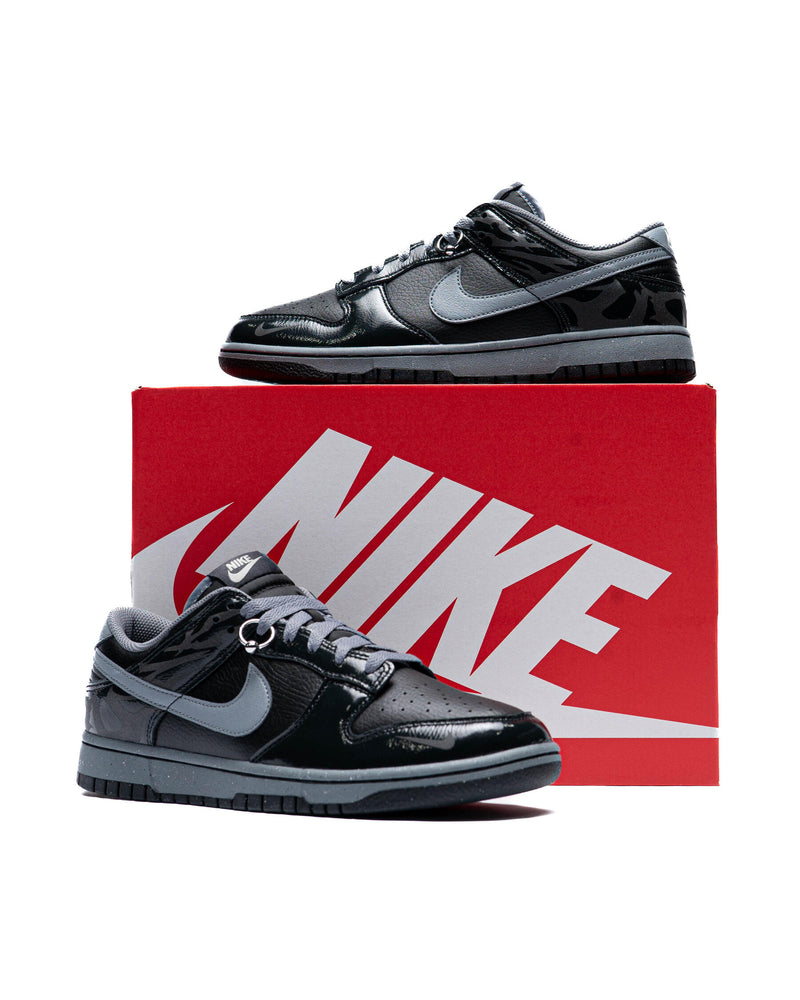 Berlin-inspired Dunk Low sneaker in black and Off-Noir, featuring glossy patent leather accents and reflective tattoo art design on the heel.