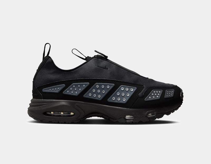 Air Max SNDR sneaker with a bold design featuring Silver accents, a black zip-up shroud, reflective design panels, Max Air cushioning in the heel, and Nike Air in the forefoot. Unzipped shroud reveals ""6453"" representing Nike’s global office numbers.