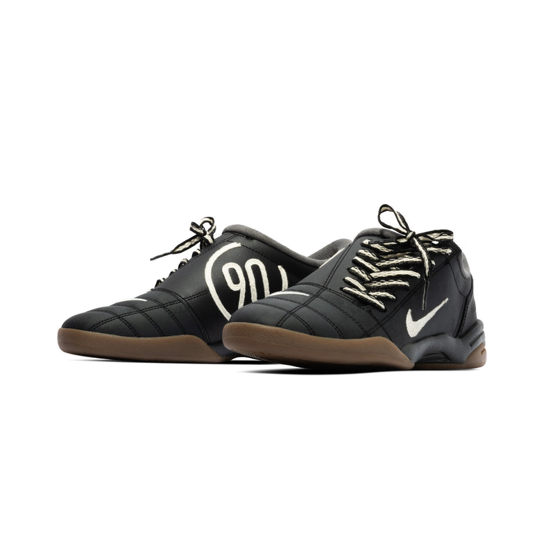 Modern Nike Total 90 with white jacquard upper, black accents, gum sole, and iconic asymmetrical lacing