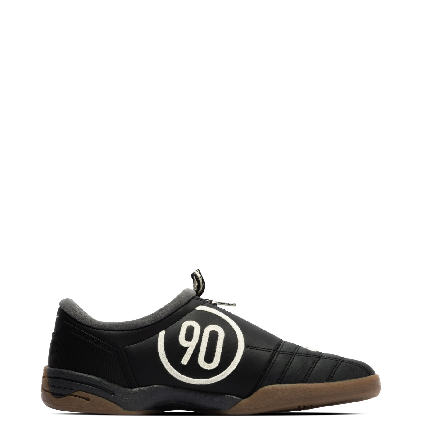 Modern Nike Total 90 with white jacquard upper, black accents, gum sole, and iconic asymmetrical lacing