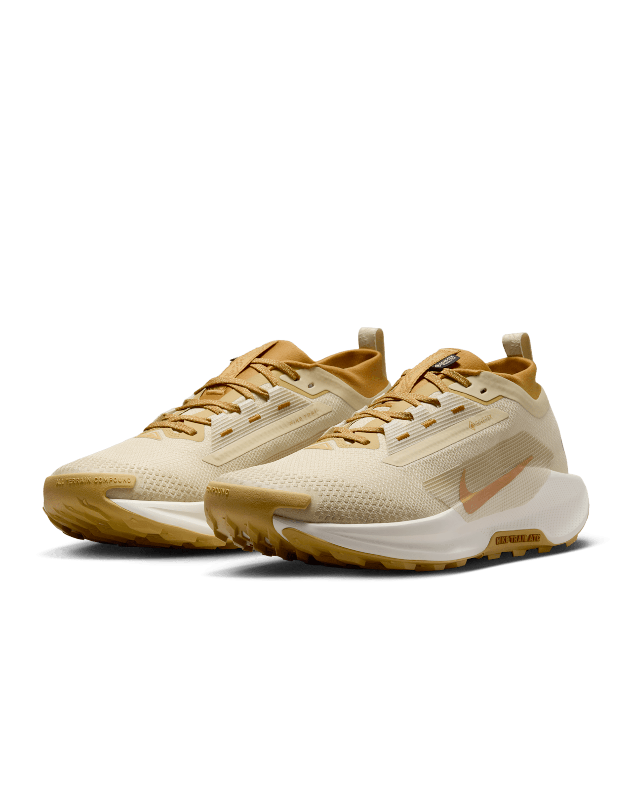 Nike Pegasus Trail 5 trail running shoe with waterproof GORE-TEX upper, ReactX foam cushioning, and rugged all-terrain outsole in Team Gold and Desert Ochre.