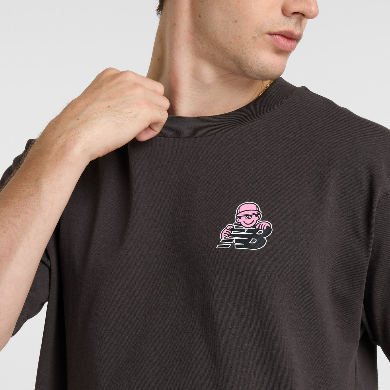 Face Oka x New Balance t-shirt featuring bold colors and playful graphic art by Tokyo-based illustrator