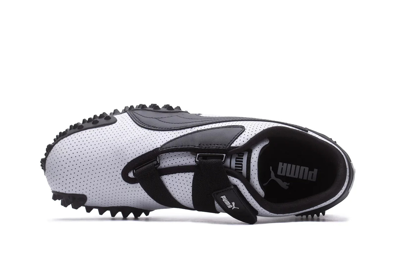 The Puma Mostro features a perforated leather upper, flat silhouette, and iconic Formstrip logo, blending influences from 1960s sprint spikes and 1980s surf shoes.