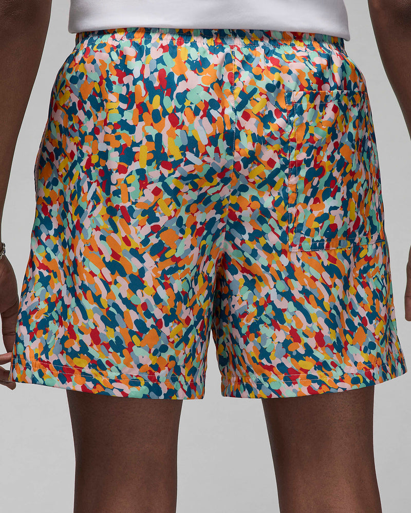 Versatile lightweight shorts with a pointillist-inspired design, suitable for land or water activities. Features include a soft shell, breathable mesh lining, and elastic drawstring waistband for a secure and comfortable fit.