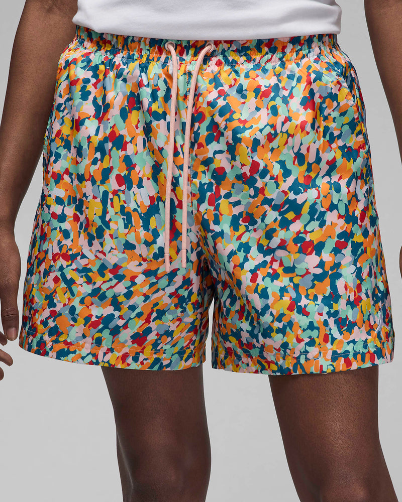 Versatile lightweight shorts with a pointillist-inspired design, suitable for land or water activities. Features include a soft shell, breathable mesh lining, and elastic drawstring waistband for a secure and comfortable fit.