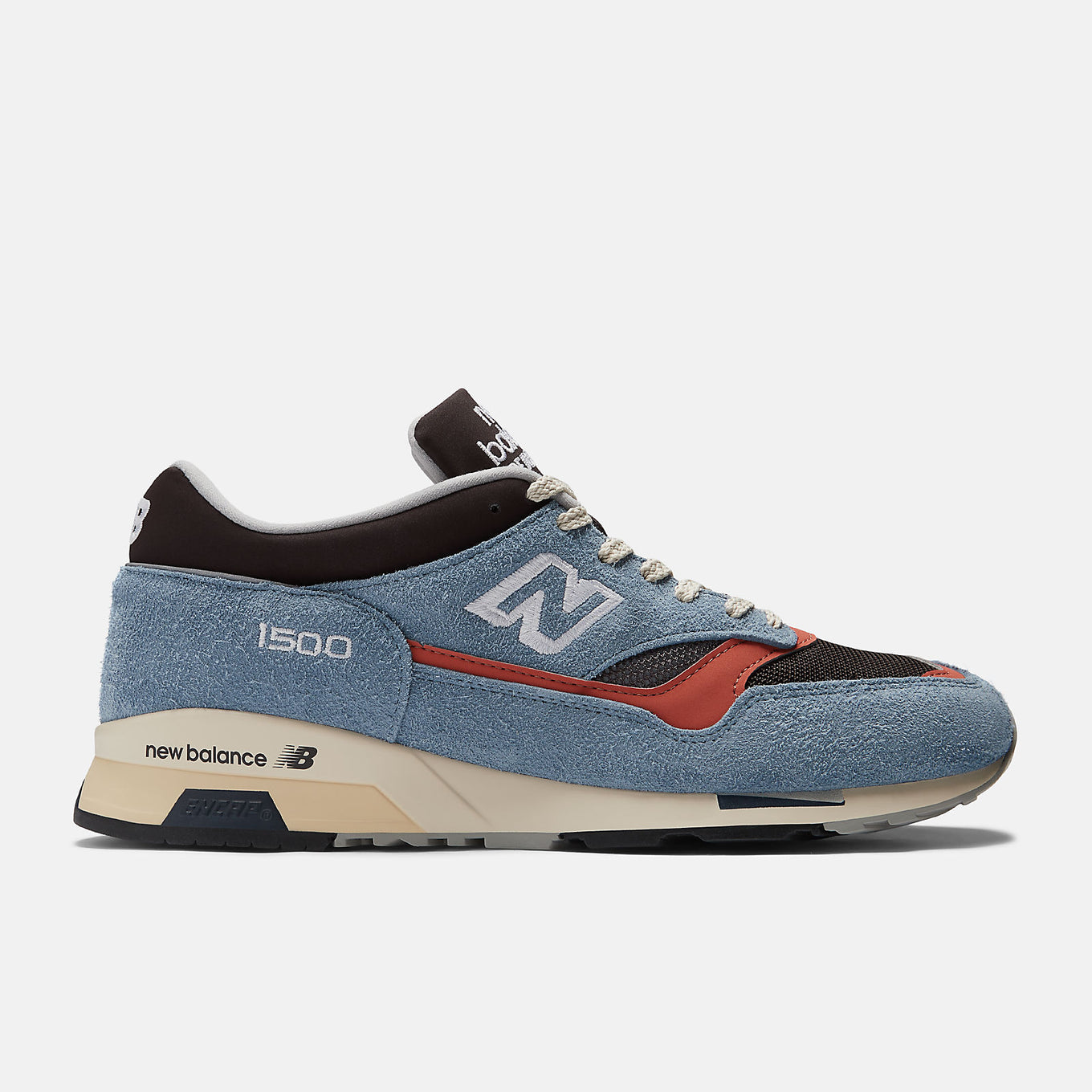 New Balance Made in UK 1500 ‘Coffee Pop’ sneaker with dark brown mesh, pale blue suede overlays, and red-orange synthetic details.