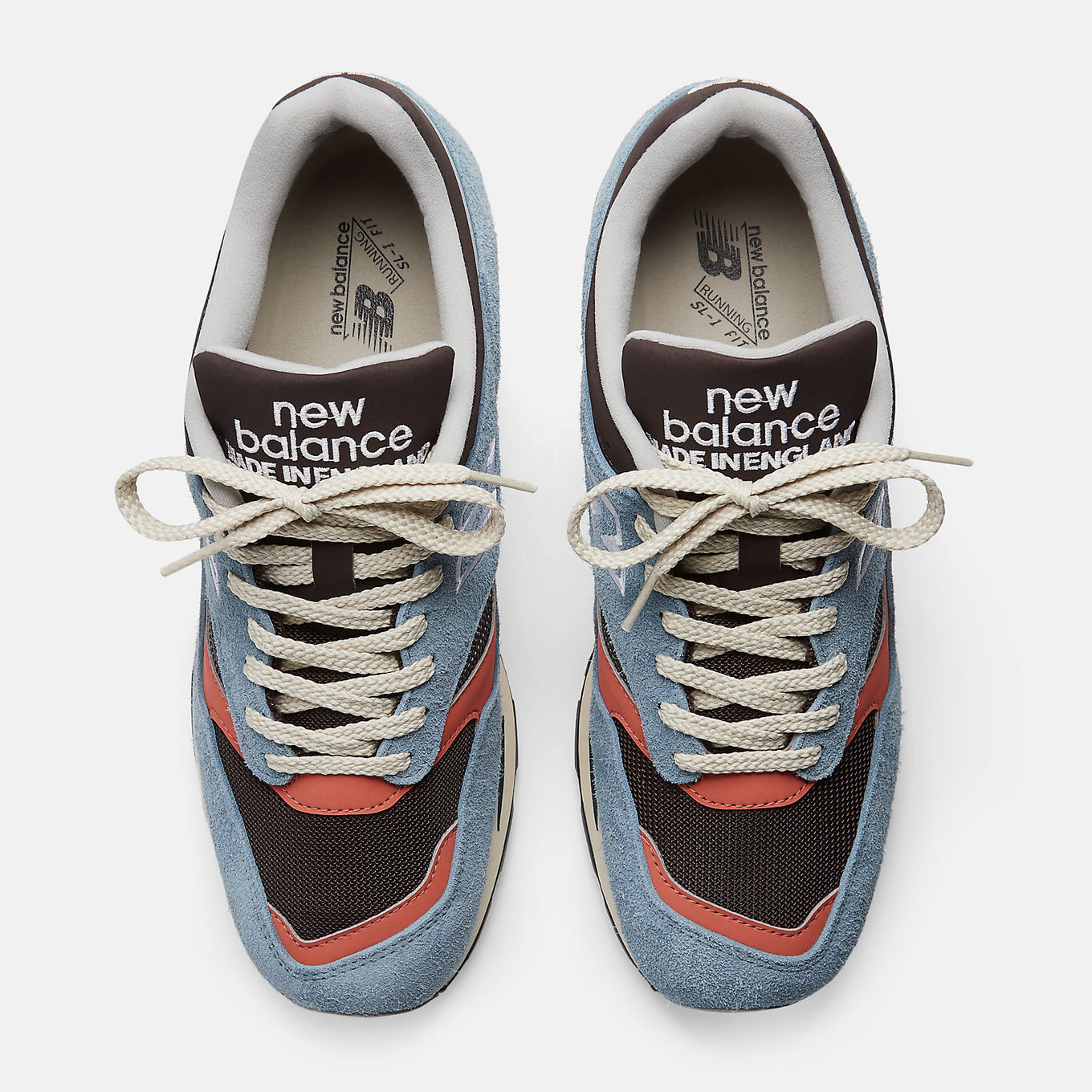 New Balance Made in UK 1500 ‘Coffee Pop’ sneaker with dark brown mesh, pale blue suede overlays, and red-orange synthetic details.