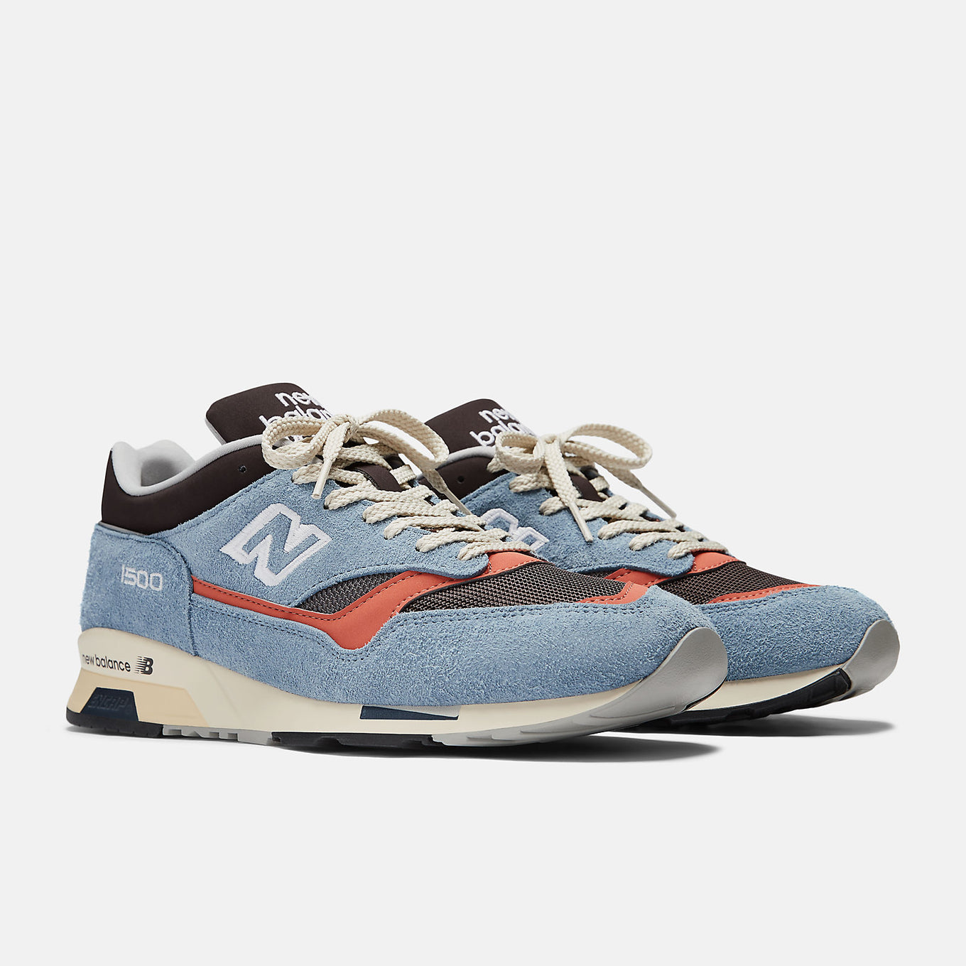 New Balance Made in UK 1500 ‘Coffee Pop’ sneaker with dark brown mesh, pale blue suede overlays, and red-orange synthetic details.