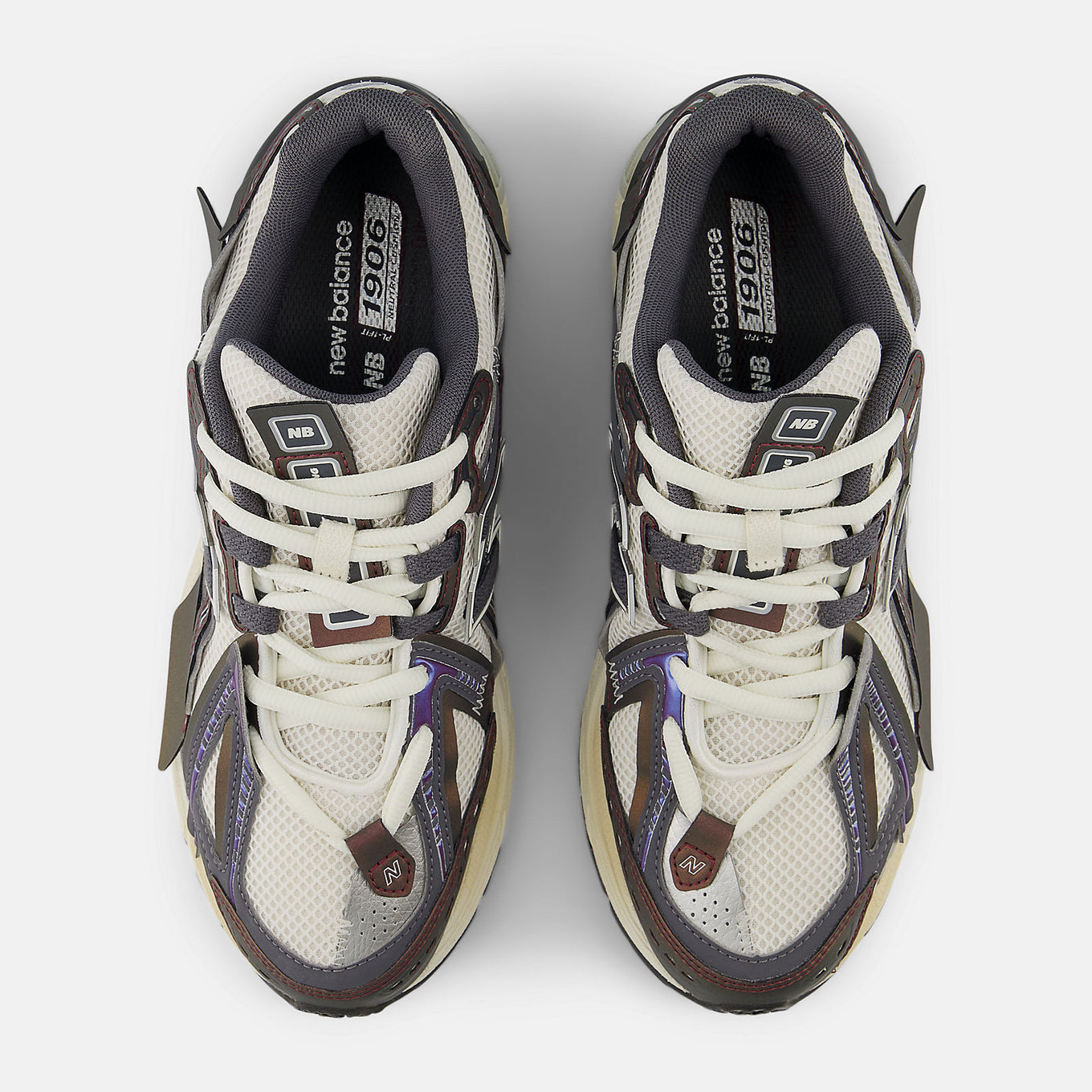 New Balance 1906A sneakers with mesh upper and ABZORB SBS heel cushioning in a retro running silhouette.
