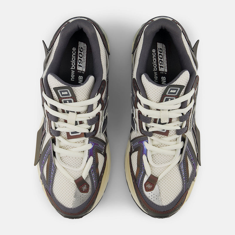 New Balance 1906A sneakers with mesh upper and ABZORB SBS heel cushioning in a retro running silhouette.
