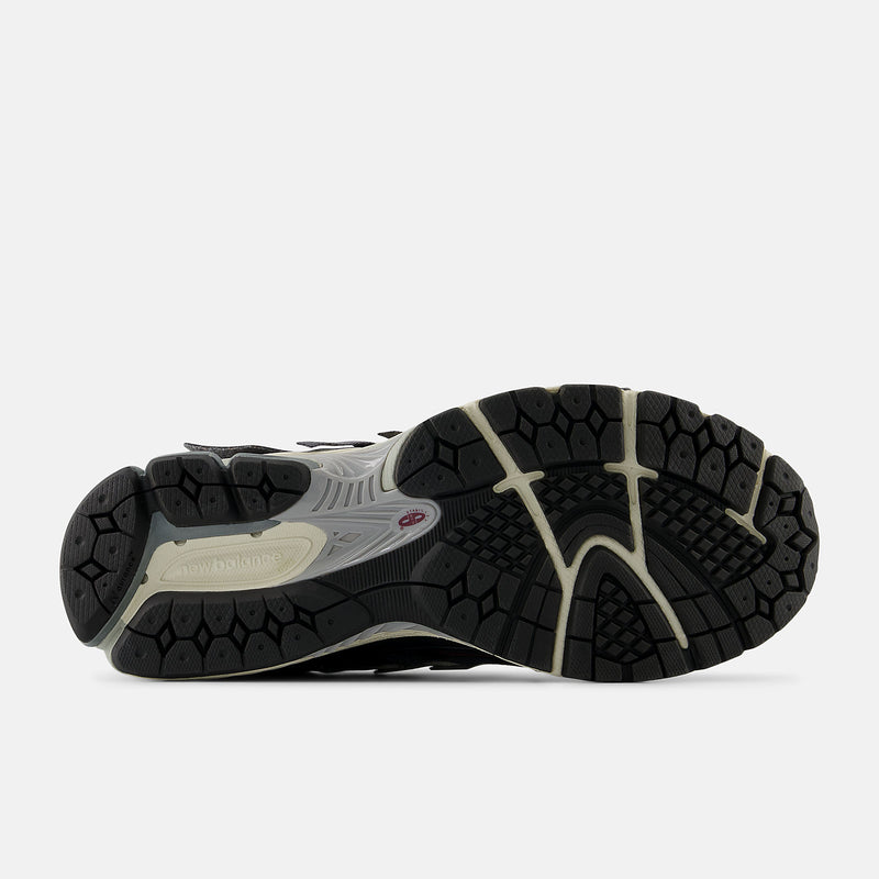 New Balance 1906A sneakers with mesh upper and ABZORB SBS heel cushioning in a retro running silhouette.