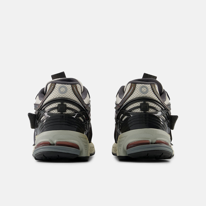 New Balance 1906A sneakers with mesh upper and ABZORB SBS heel cushioning in a retro running silhouette.