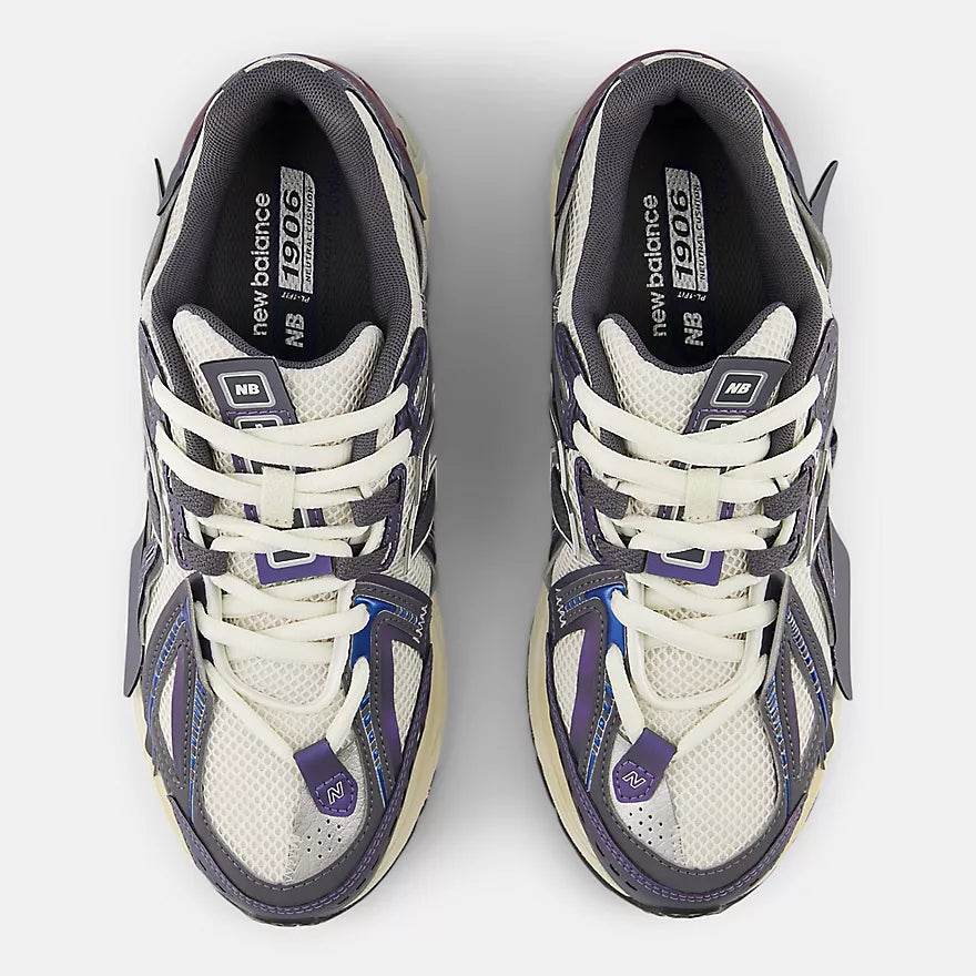 New Balance 1906A sneakers with mesh upper and ABZORB SBS heel cushioning in a retro running silhouette.