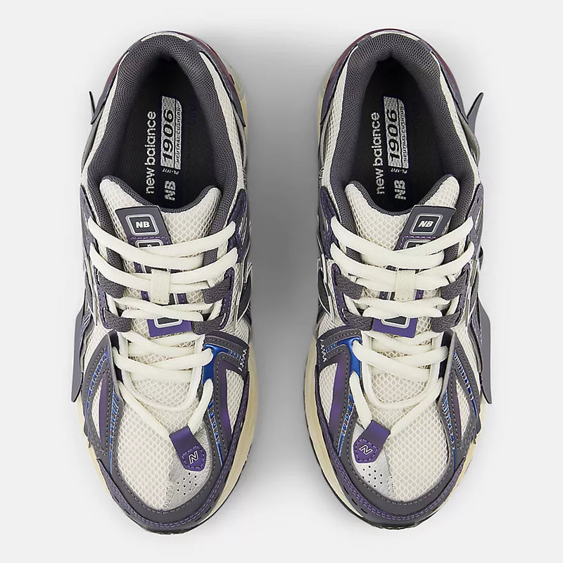 New Balance 1906A sneakers with mesh upper and ABZORB SBS heel cushioning in a retro running silhouette.