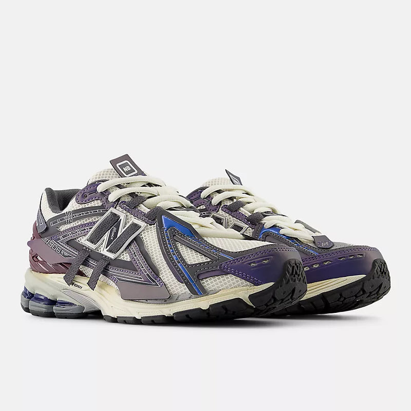 New Balance 1906A sneakers with mesh upper and ABZORB SBS heel cushioning in a retro running silhouette.