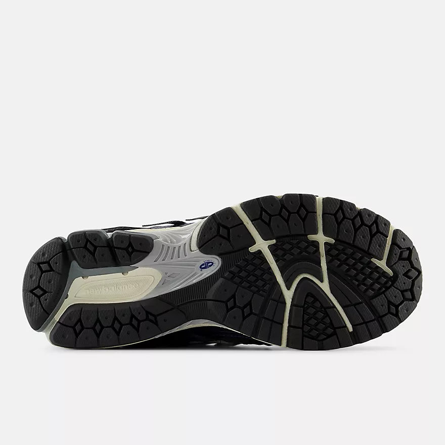 New Balance 1906A sneakers with mesh upper and ABZORB SBS heel cushioning in a retro running silhouette.