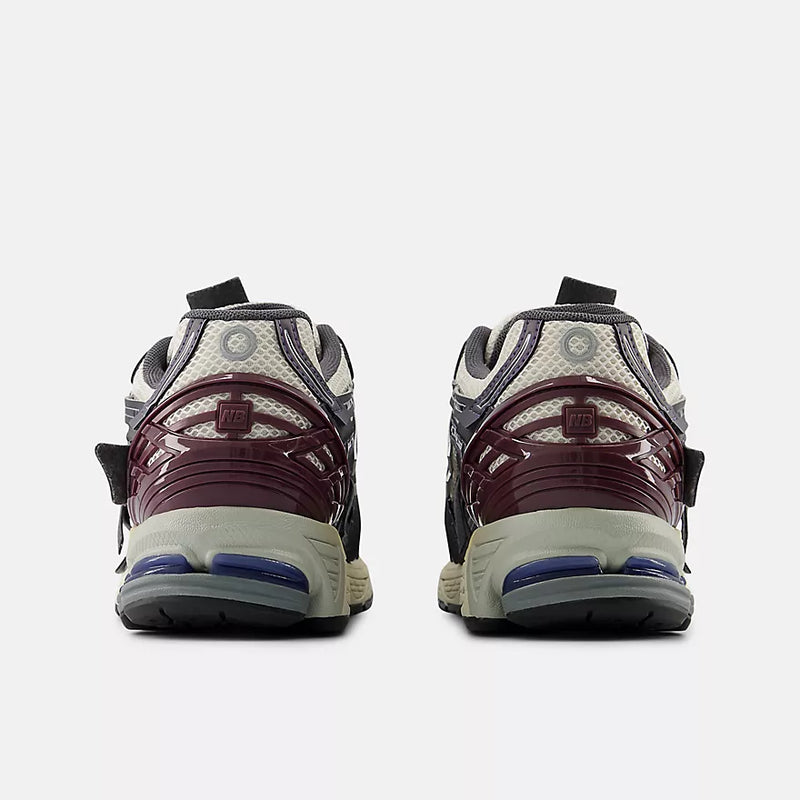 New Balance 1906A sneakers with mesh upper and ABZORB SBS heel cushioning in a retro running silhouette.