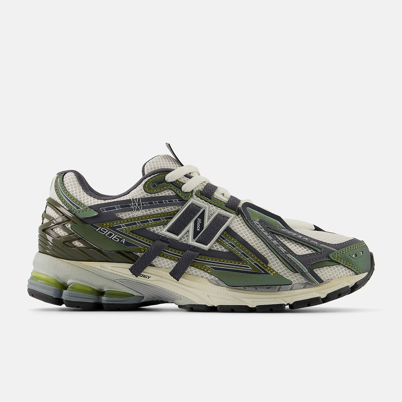 New Balance 1906A sneakers with mesh upper and ABZORB SBS heel cushioning in a retro running silhouette.