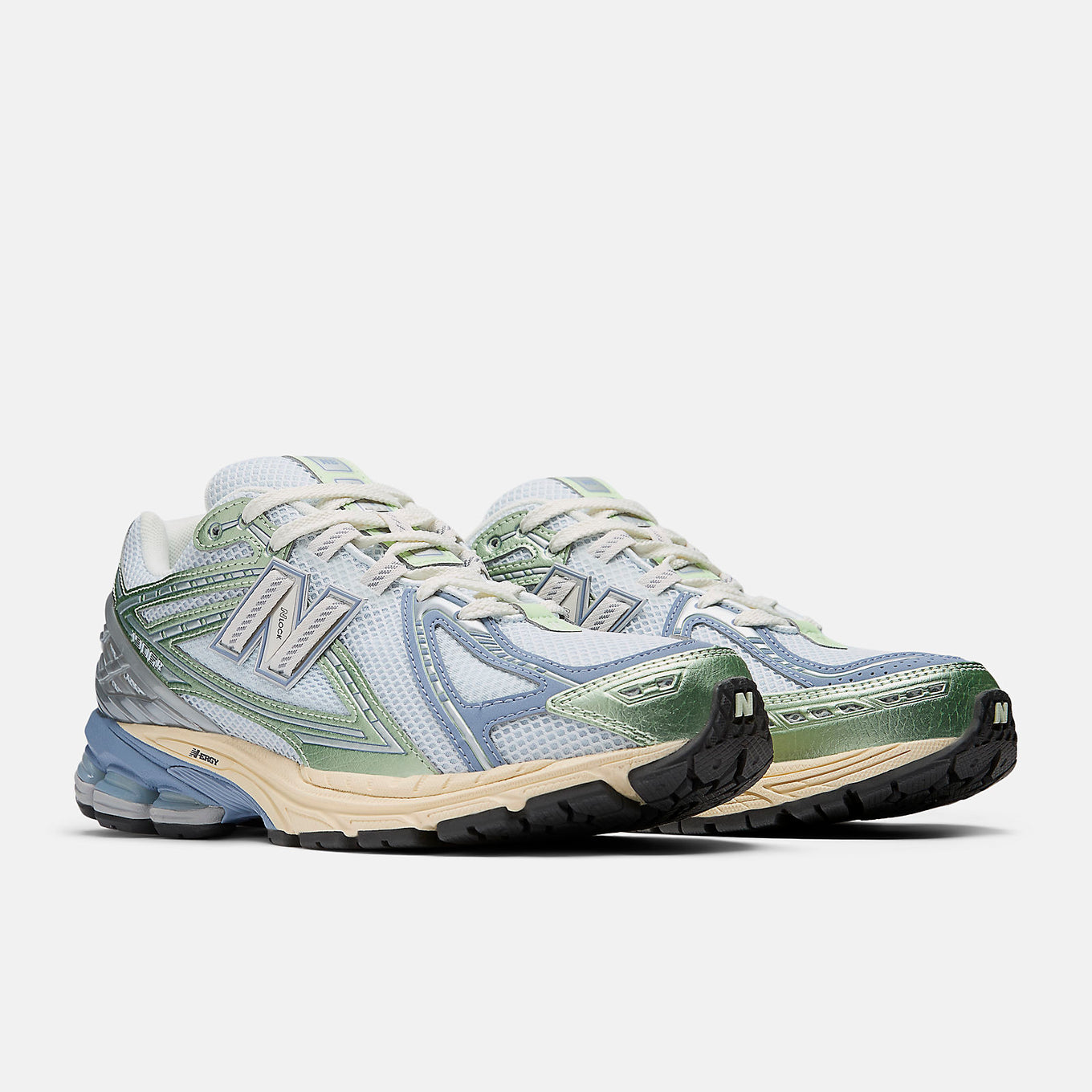 New Balance 1906R sneaker with open-holed mesh upper, curvilinear overlays, and advanced cushioning sole