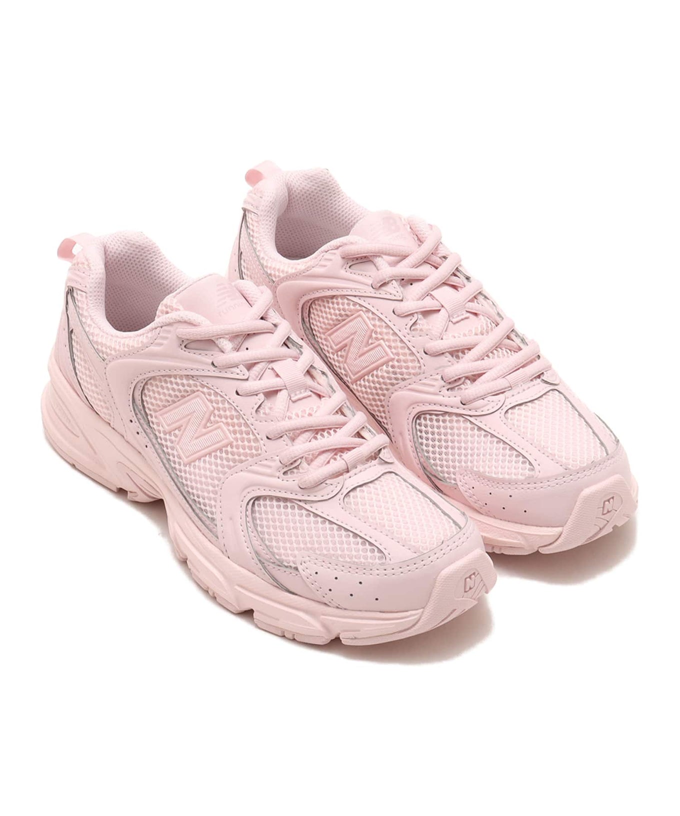 New Balance 530 sneaker in exclusive light pink colorway, featuring elegant curves and ABZORB midsole for spring-ready style