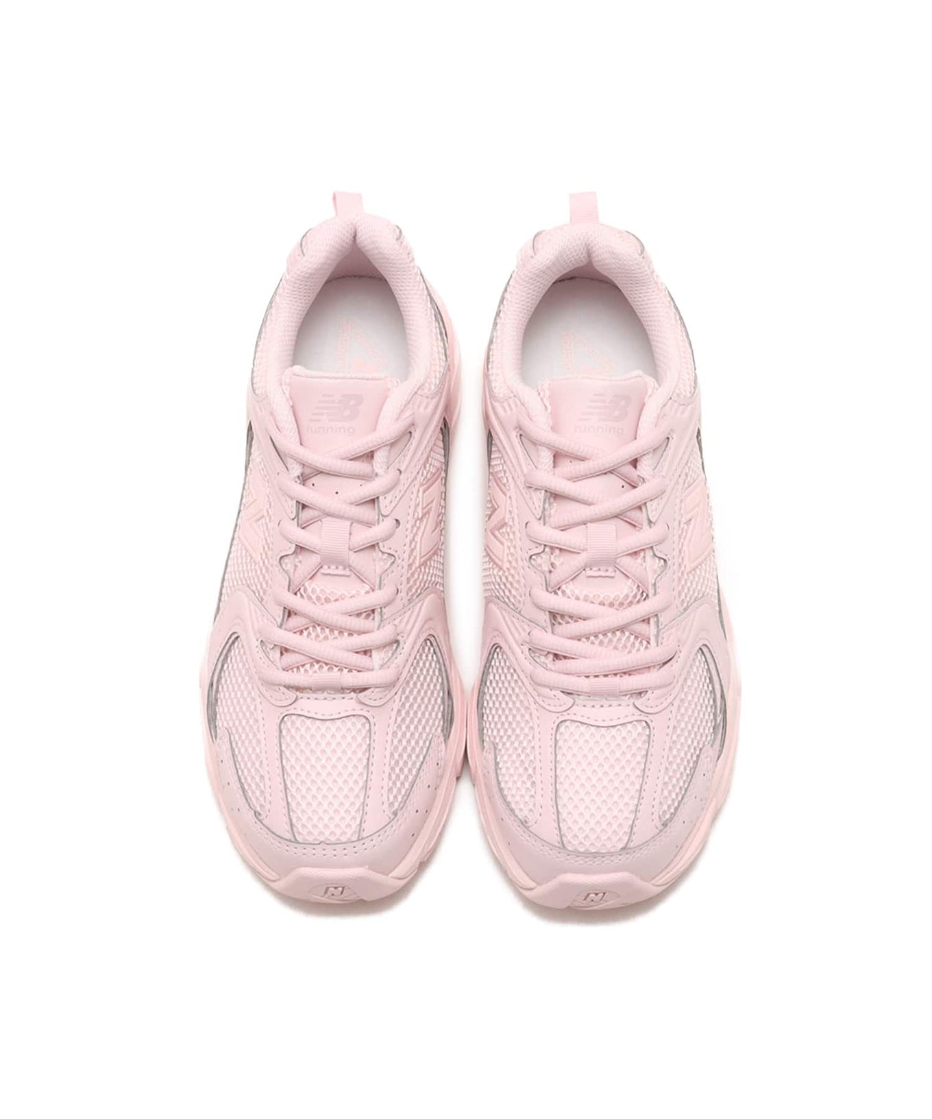 New Balance 530 sneaker in exclusive light pink colorway, featuring elegant curves and ABZORB midsole for spring-ready style