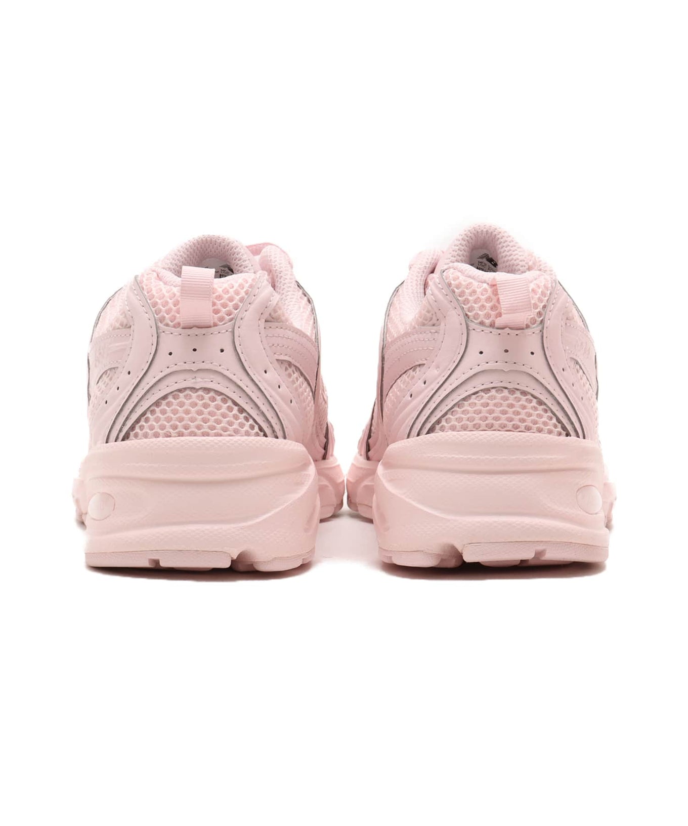 New Balance 530 sneaker in exclusive light pink colorway, featuring elegant curves and ABZORB midsole for spring-ready style