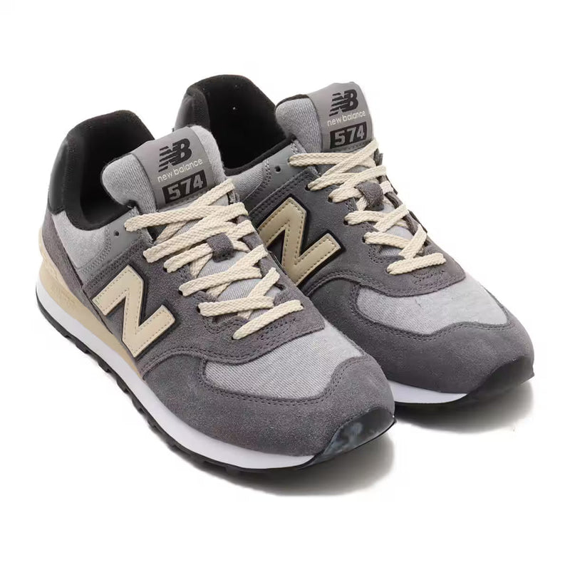 New Balance 574 shoes, an iconic hybrid road and trail design, showcasing a versatile mix of rugged durability and comfort, embodying the unpretentious style that makes them a global staple.