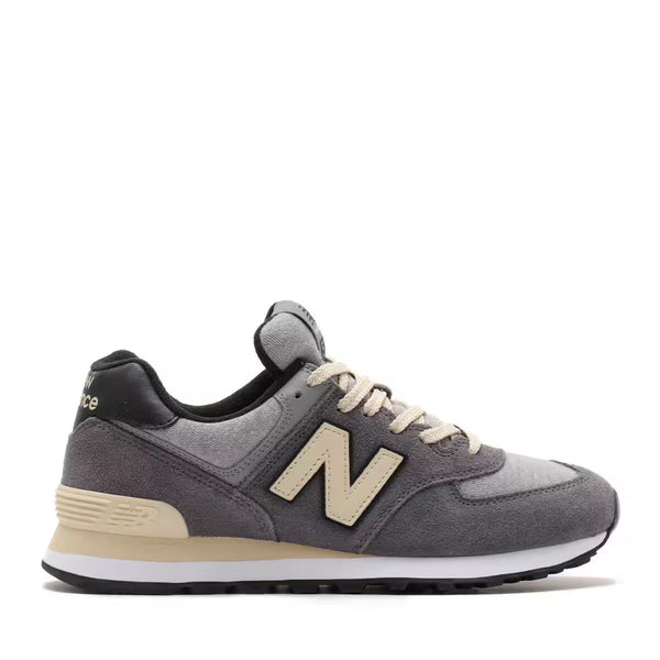 New Balance 574 shoes, an iconic hybrid road and trail design, showcasing a versatile mix of rugged durability and comfort, embodying the unpretentious style that makes them a global staple.