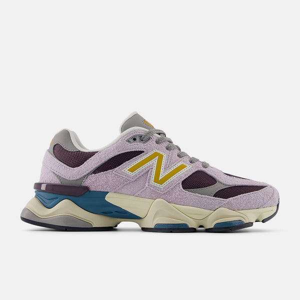 New Balance 9060 sneaker featuring futuristic design elements, including expanded sway bars, wavy lines, and sculpted midsole, with ABZORB and SBS cushioning.