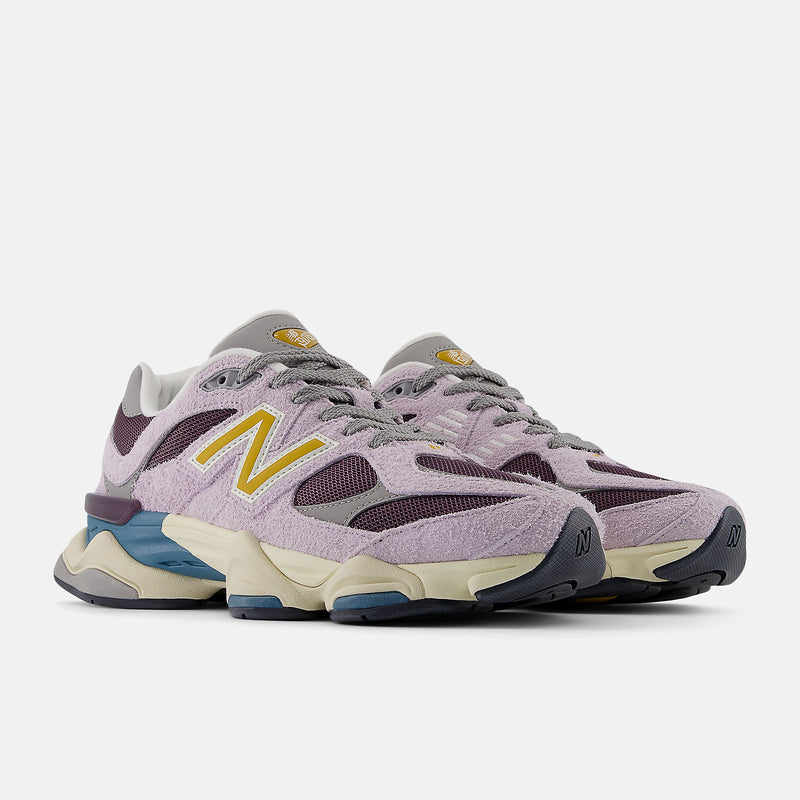 New Balance 9060 sneaker featuring futuristic design elements, including expanded sway bars, wavy lines, and sculpted midsole, with ABZORB and SBS cushioning.