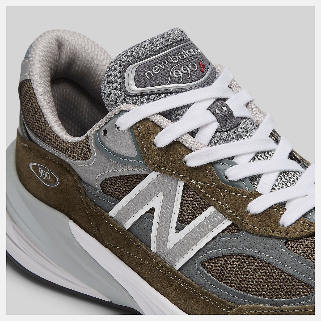 New Balance Made in USA 990v6 sneaker with a streamlined suede and mesh upper, FuelCell cushioning, and a modern grey colorway.
