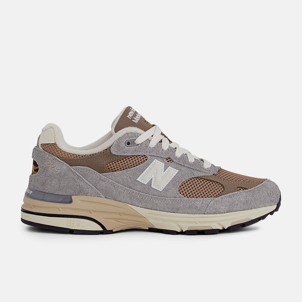 New Balance 993 Made in USA sneakers with driftwood brown mesh upper and shadow grey hairy suede on a dual-colored white and off-white midsole.


