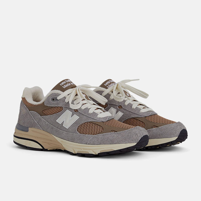 New Balance 993 Made in USA sneakers with driftwood brown mesh upper and shadow grey hairy suede on a dual-colored white and off-white midsole.


