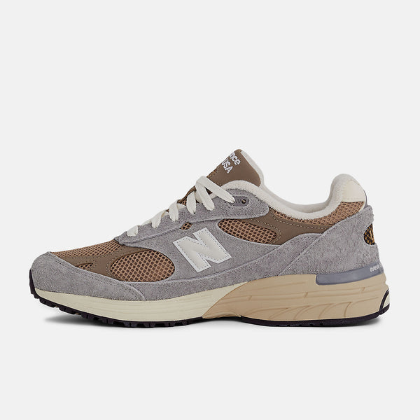 New Balance 993 Made in USA sneakers with driftwood brown mesh upper and shadow grey hairy suede on a dual-colored white and off-white midsole.


