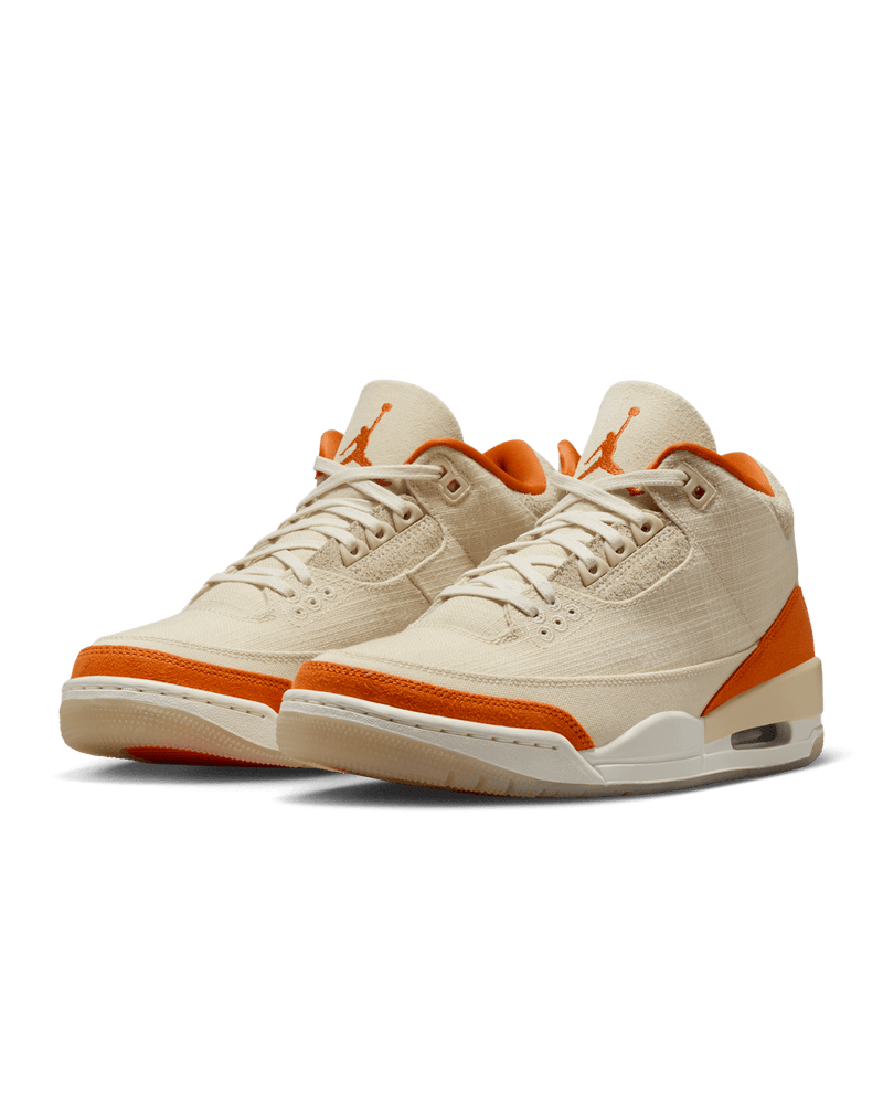 Women’s Air Jordan 3 sneakers in neutral canvas and suede with orange accents, inspired by MJ’s legendary backboard-shattering exhibition game in Italy.
