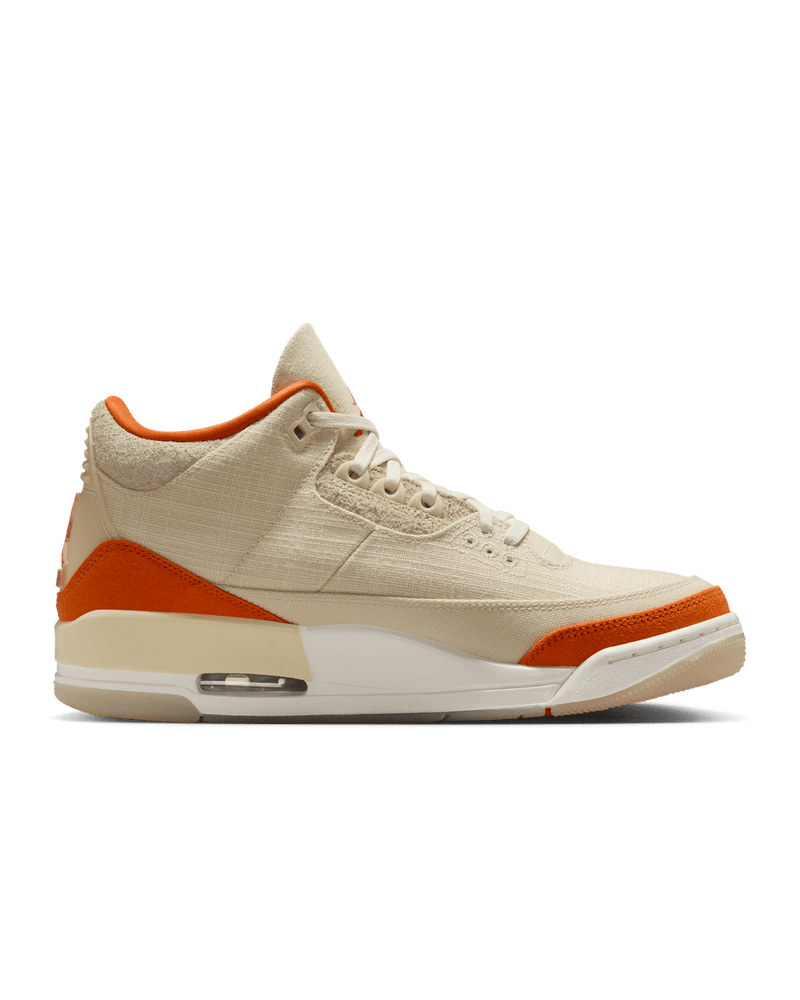 Women’s Air Jordan 3 sneakers in neutral canvas and suede with orange accents, inspired by MJ’s legendary backboard-shattering exhibition game in Italy.