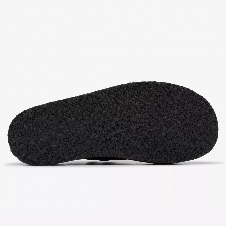 Clarks Originals Trek wedge heel mules in black suede, showcasing a slip-on design with an adjustable pin-buckle strap, center split seam, and rounded toeline