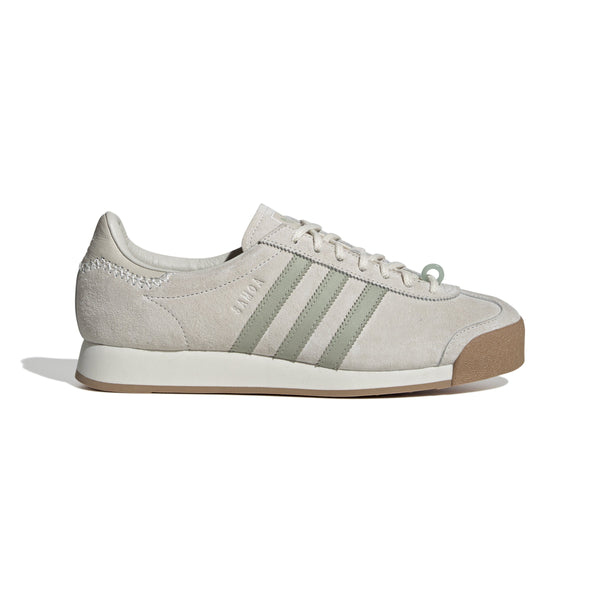 Maha Amsterdam, a prominent women’s streetwear store established in 2015 by Saskia van Hofwegen and Dian Iskandar, collaborates with adidas on the classic sneaker from the late '70s—the adidas Samoa. This design features a low-cut silhouette with a suede upper in "Chalk White," complemented by subtle green accents, comfortable padding, and a cushioned sole. The laces include a jade-colored lace jewel, along with adidas and Maha logo details for added flair.