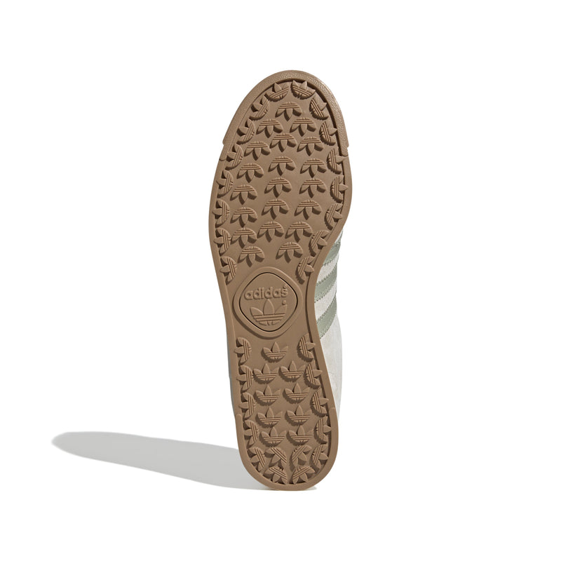 Maha Amsterdam, a prominent women’s streetwear store established in 2015 by Saskia van Hofwegen and Dian Iskandar, collaborates with adidas on the classic sneaker from the late '70s—the adidas Samoa. This design features a low-cut silhouette with a suede upper in "Chalk White," complemented by subtle green accents, comfortable padding, and a cushioned sole. The laces include a jade-colored lace jewel, along with adidas and Maha logo details for added flair.