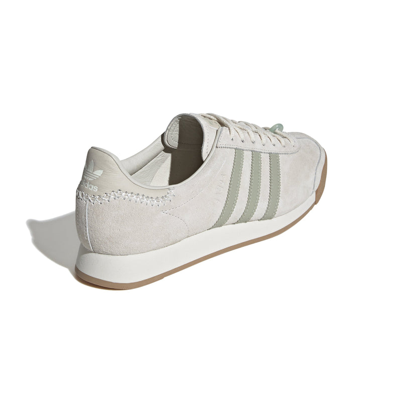 Maha Amsterdam, a prominent women’s streetwear store established in 2015 by Saskia van Hofwegen and Dian Iskandar, collaborates with adidas on the classic sneaker from the late '70s—the adidas Samoa. This design features a low-cut silhouette with a suede upper in "Chalk White," complemented by subtle green accents, comfortable padding, and a cushioned sole. The laces include a jade-colored lace jewel, along with adidas and Maha logo details for added flair.
